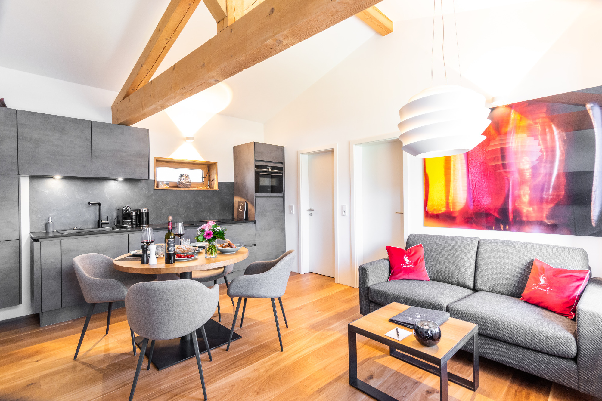 Open-plan living, dining, sofa, and kitchen area in the “Franzl” holiday apartment at Seeheimat in Schliersee