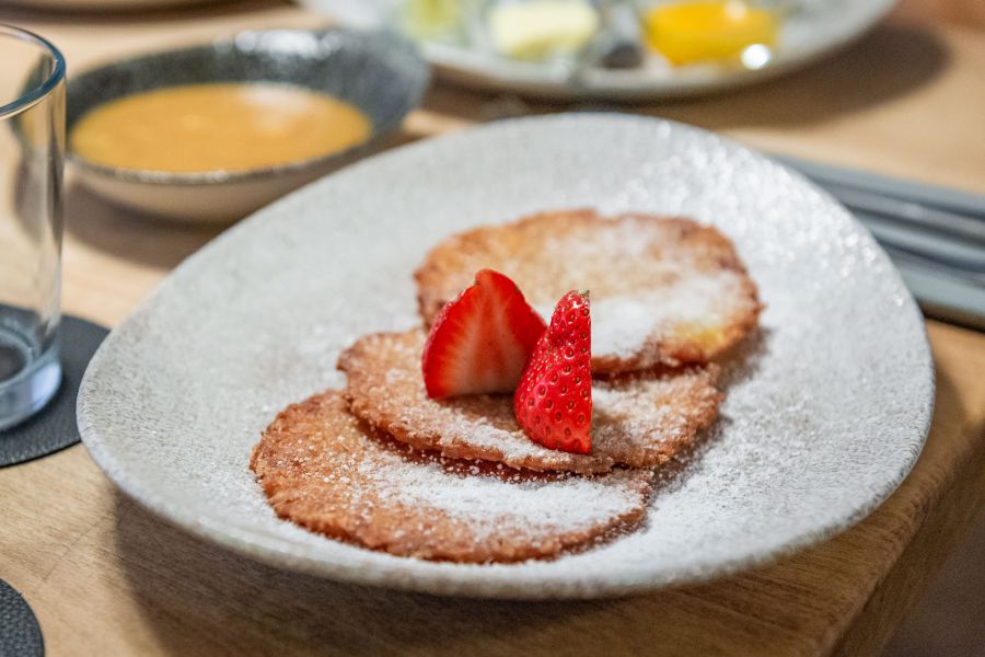 Potato pancakes with fresh applesauce and strawberry garnish at Restaurant Xaver in Schliersee