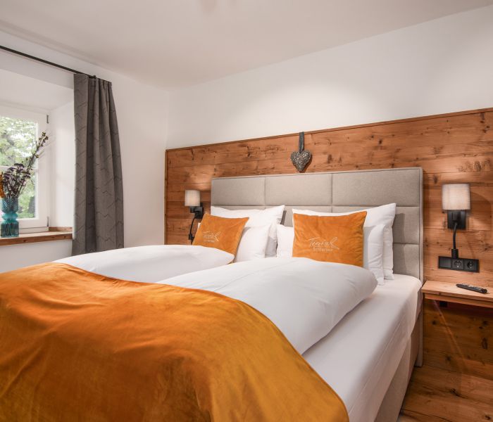 Deluxe room at Hotel Terofal in Schliersee with separate bedroom and double bed