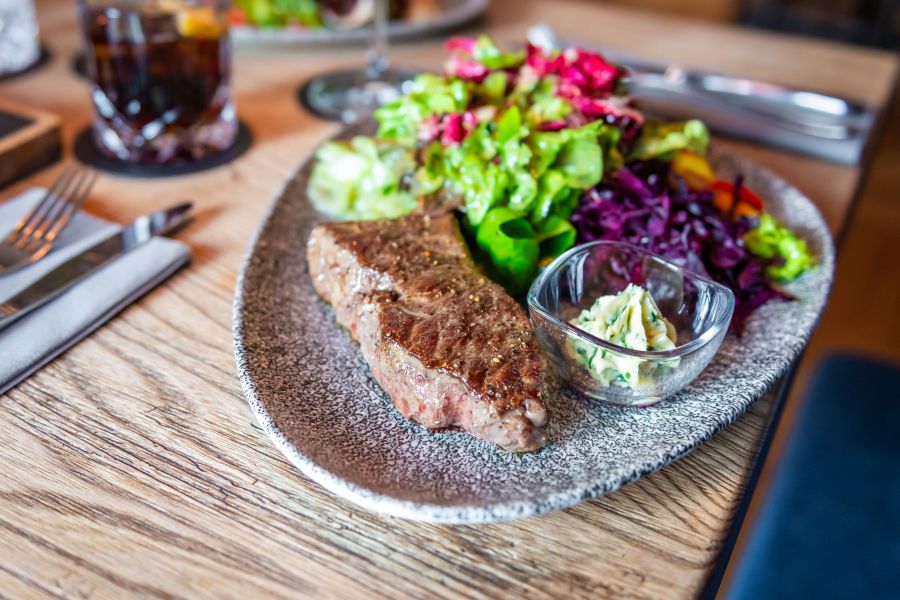 Beef steak with fresh side salad and homemade herb butter