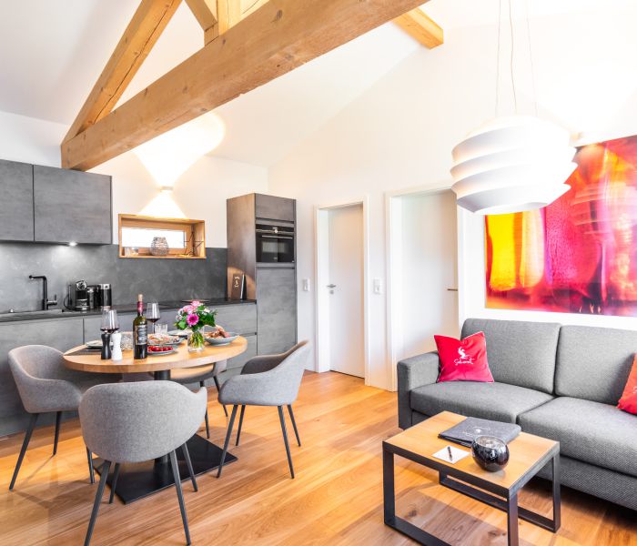 Open-plan living, dining, sofa, and kitchen area in the “Franzl” holiday apartment at Seeheimat in Schliersee