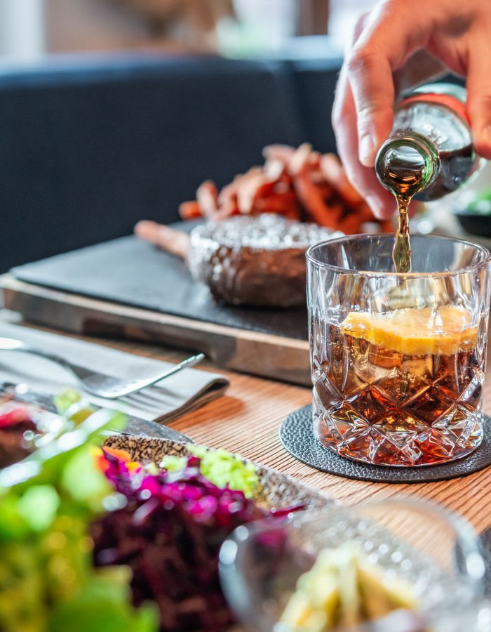 A waiter at Restaurant Xaver in Schliersee pouring a caffeinated beverage
