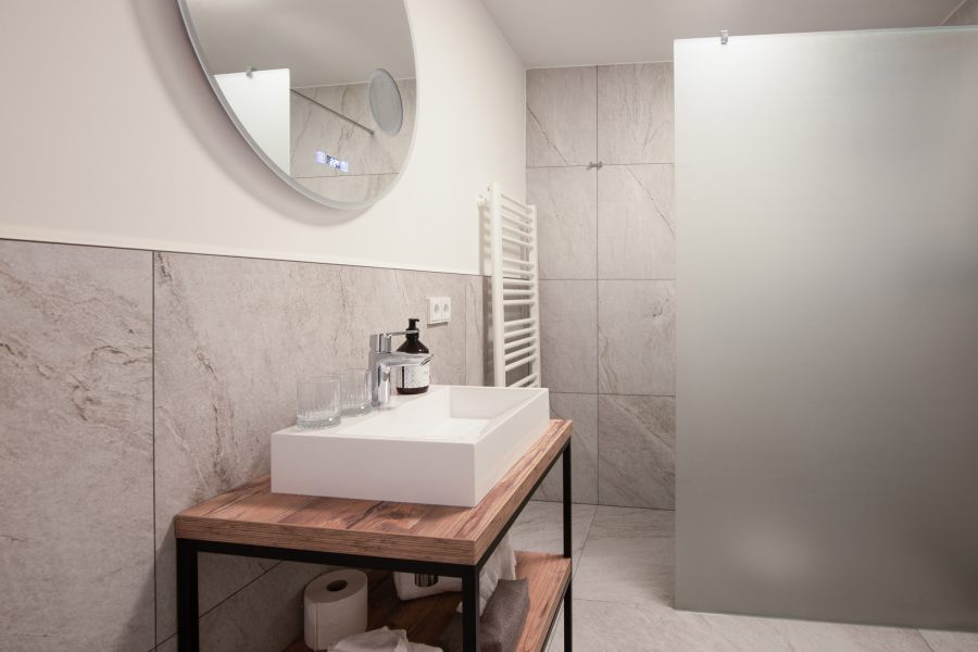 Bathroom with shower in the Deluxe room at Hotel Terofal in Schliersee